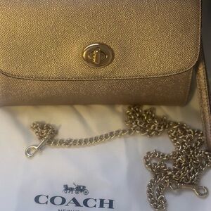 Coach gold essential clutch with gold chain. New with tags!